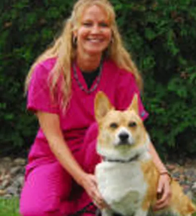 Cindy's staff photo from Stillwater Veterinary Clinic with her Corgi dog posing with her for a photo